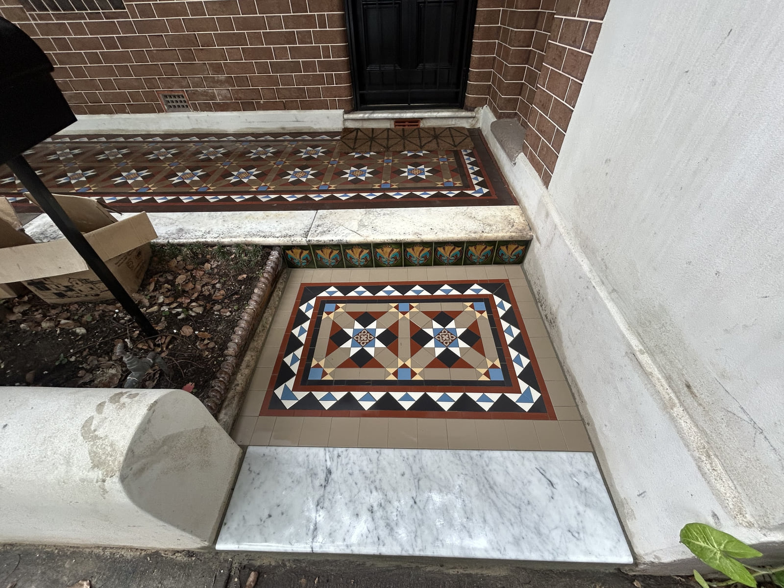 Restored Fitzroy verandah and landing with a marble step and encaustic wall tiles, Newtown